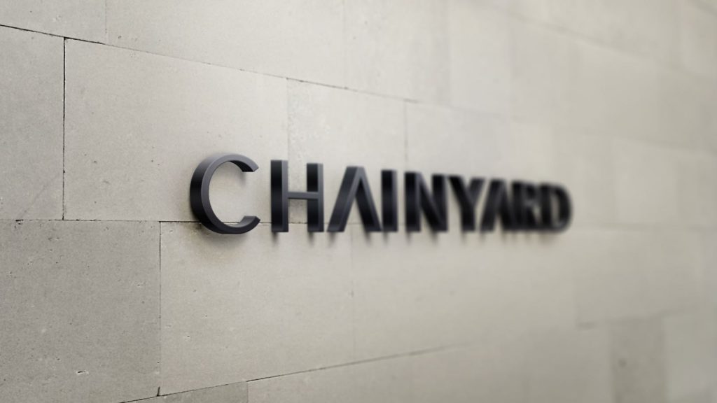 The Chainyard logo mounted on a brick wall